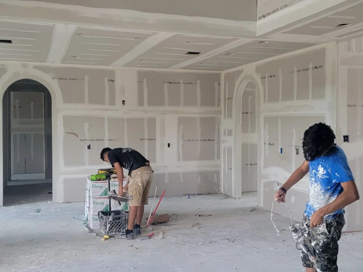 Crew finishing a great room with arched openings