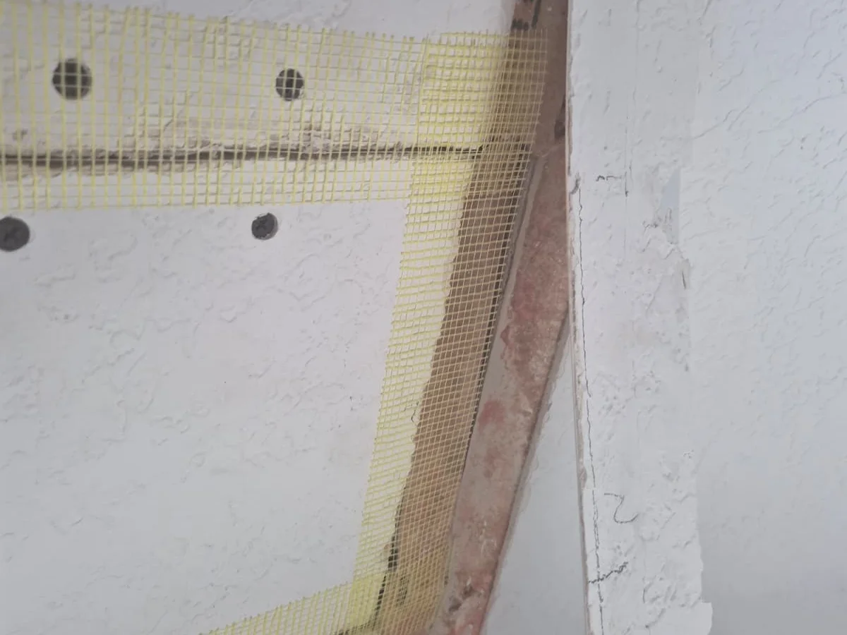 Mesh tape patch on a wall corner before mud